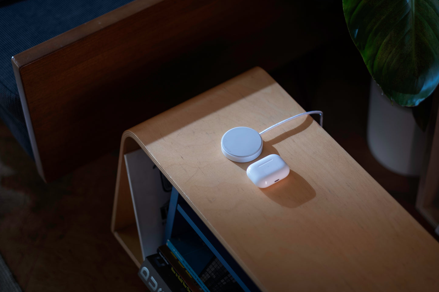 Two white electronic devices on a wooden surface with a dark background